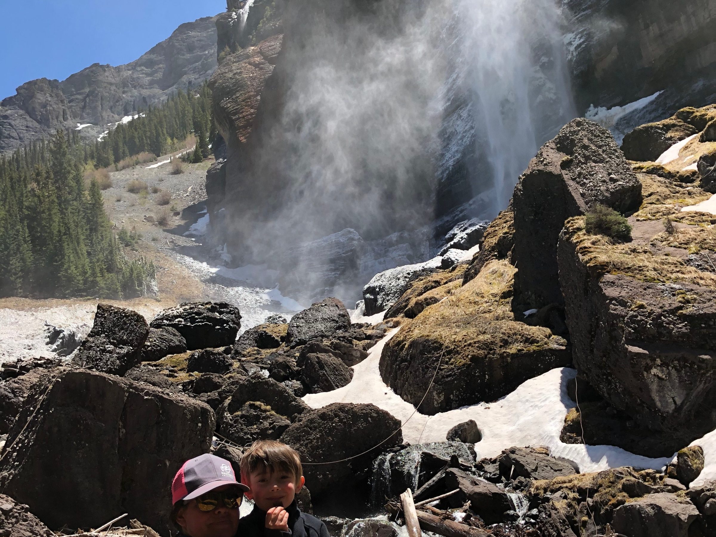 a man standing next to a waterfall