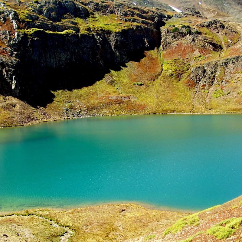 a close up of a rock next to a body of water