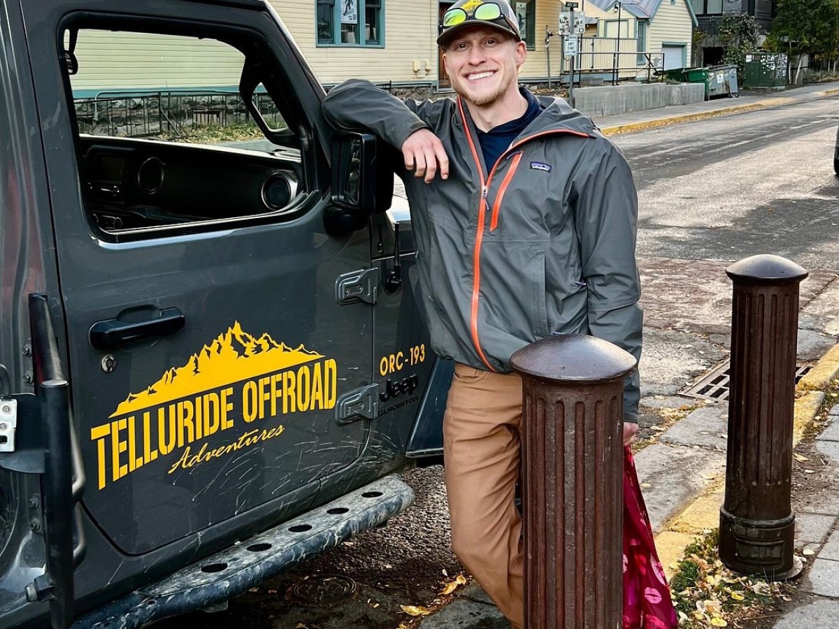 a man standing in front of a car
