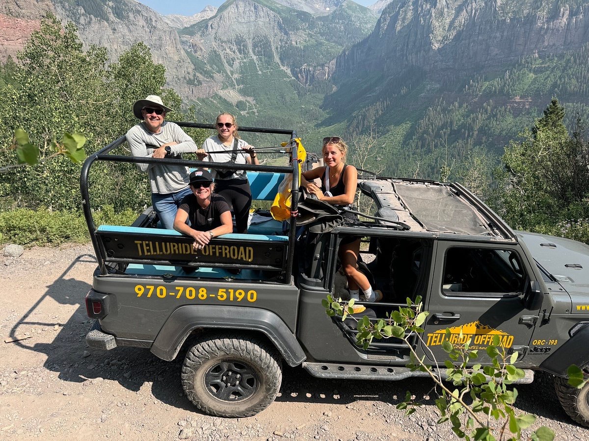 a group of people riding on the back of a truck