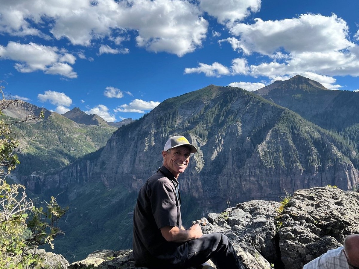 a man standing in front of a mountain