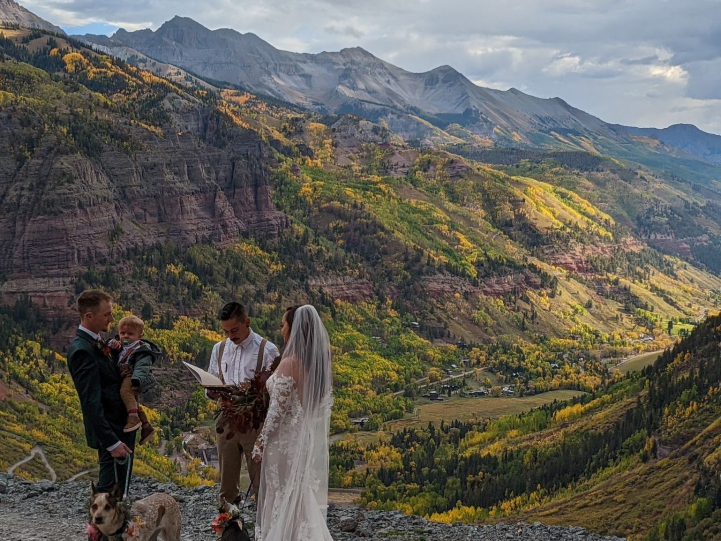 a group of people standing on top of a mountain